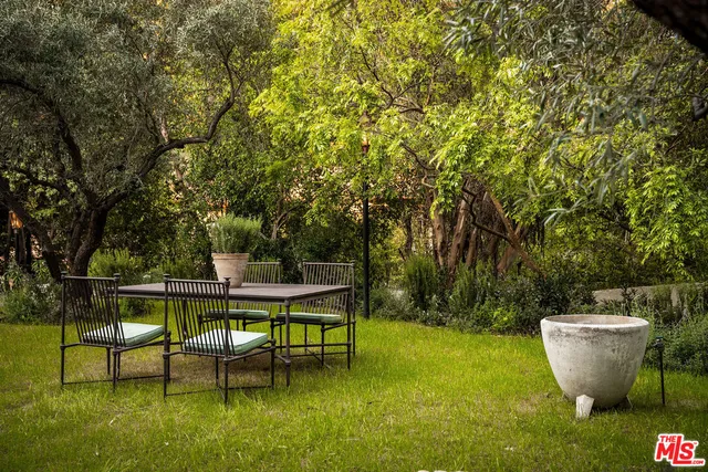 a view of a backyard with table and chairs