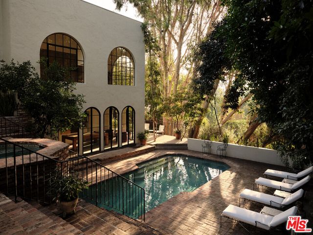 a view of a swimming pool with a patio