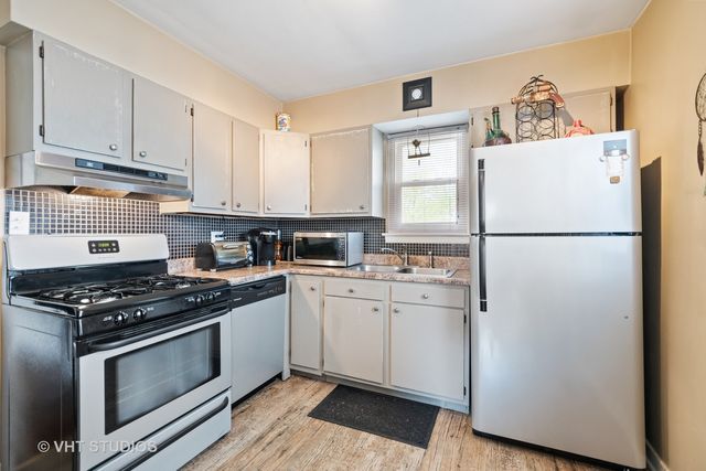 a kitchen with stainless steel appliances a refrigerator sink and cabinets