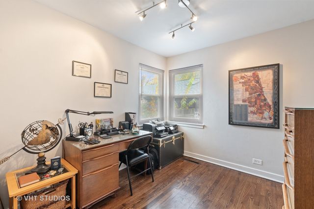 a room with gym equipment and wooden floor
