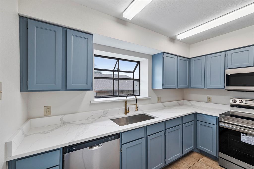 5335 Bent Tree Forest Drive, Unit 288 Dallas, TX 75248 - Photo 5 of 27 a kitchen with a sink and cabinets