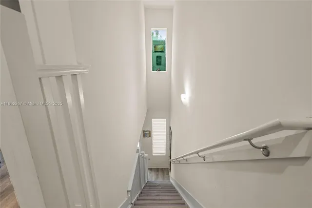 a spacious bedroom with a bed and a flat tv screen