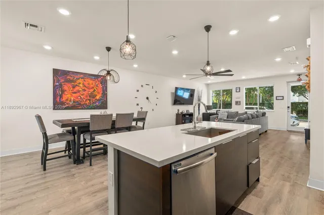 a kitchen with stainless steel appliances granite countertop a sink a stove and a refrigerator