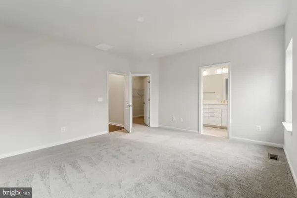 a view of an empty room with glass door
