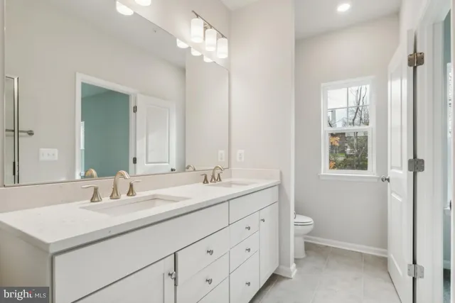 a bathroom with a sink double vanity granite and a mirror
