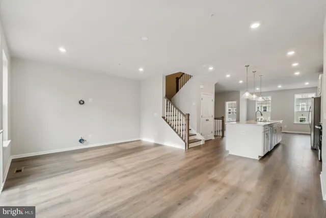 a view of an empty room and wooden floor