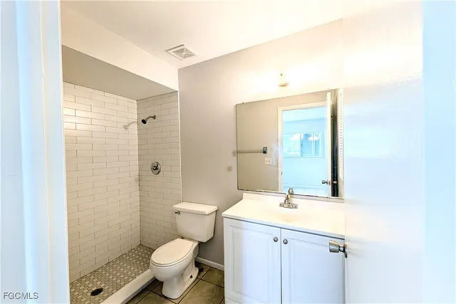a bathroom with a toilet sink and shower