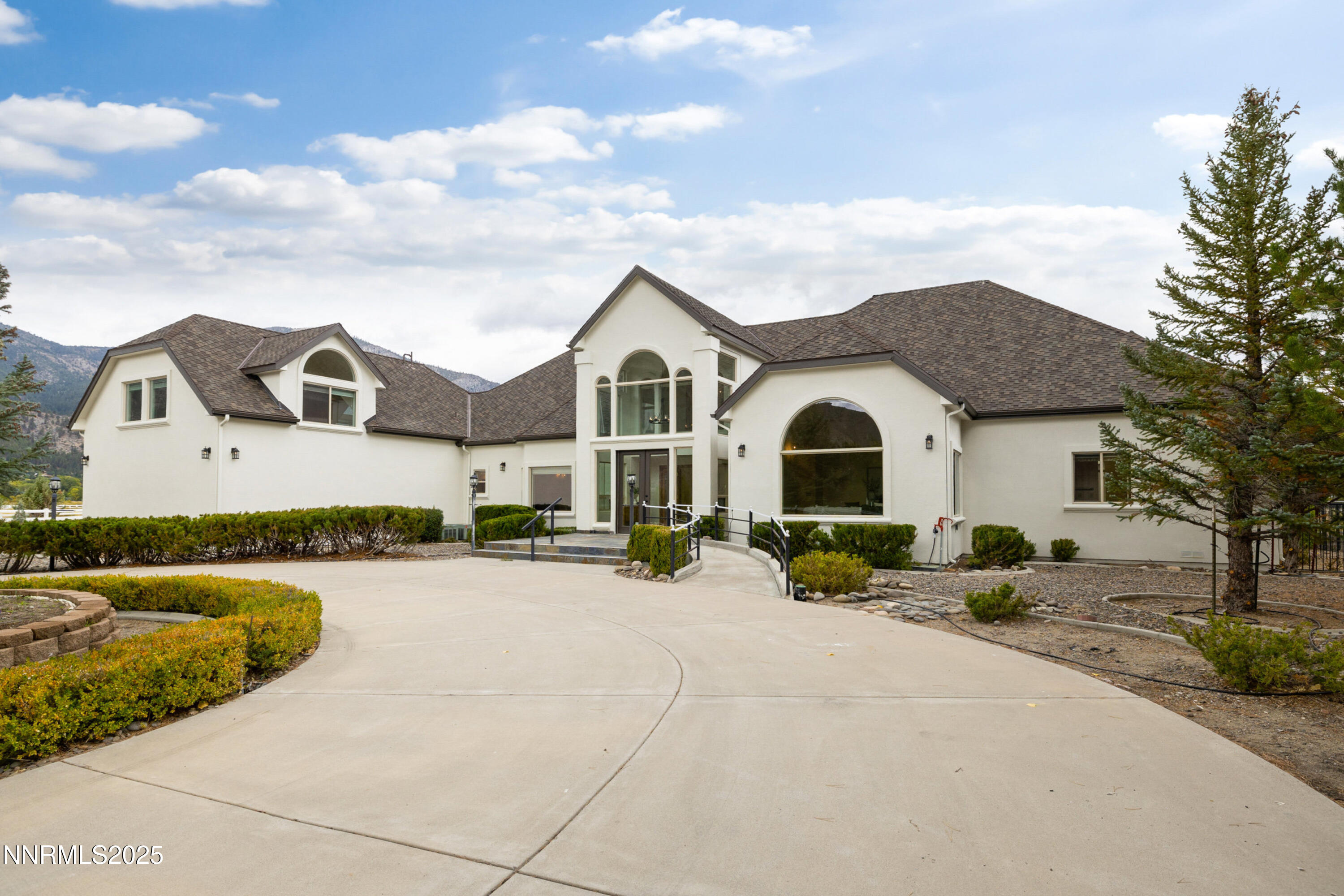 370 Genoa Lane Minden, NV 89423 - Photo 14 of 54 a front view of a house with a yard and garage