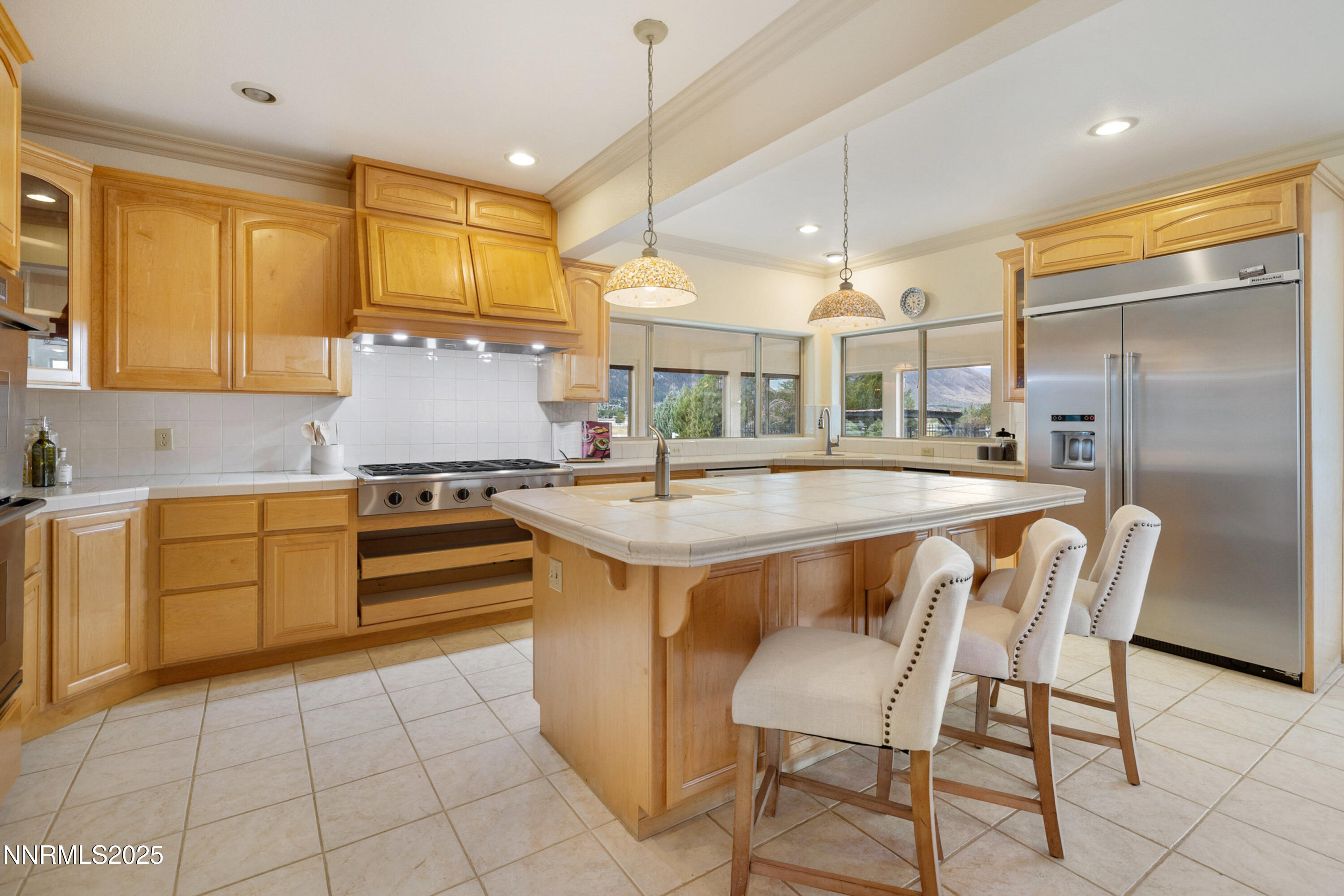 370 Genoa Lane Minden, NV 89423 - Photo 20 of 54 a kitchen with kitchen island granite countertop a stove a sink a dining table and chairs with wooden floor