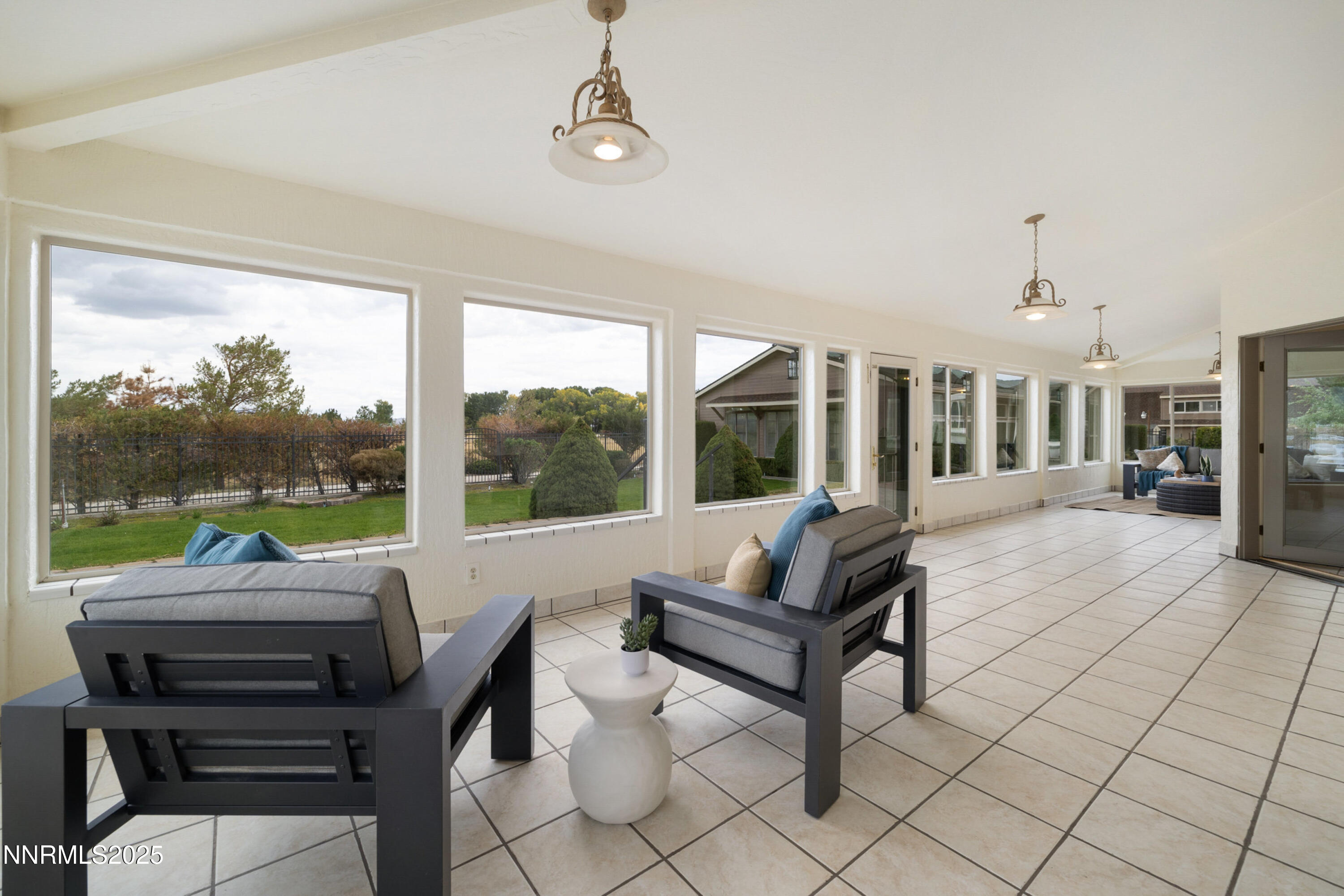 370 Genoa Lane Minden, NV 89423 - Photo 23 of 54 a living room with furniture and a floor to ceiling window