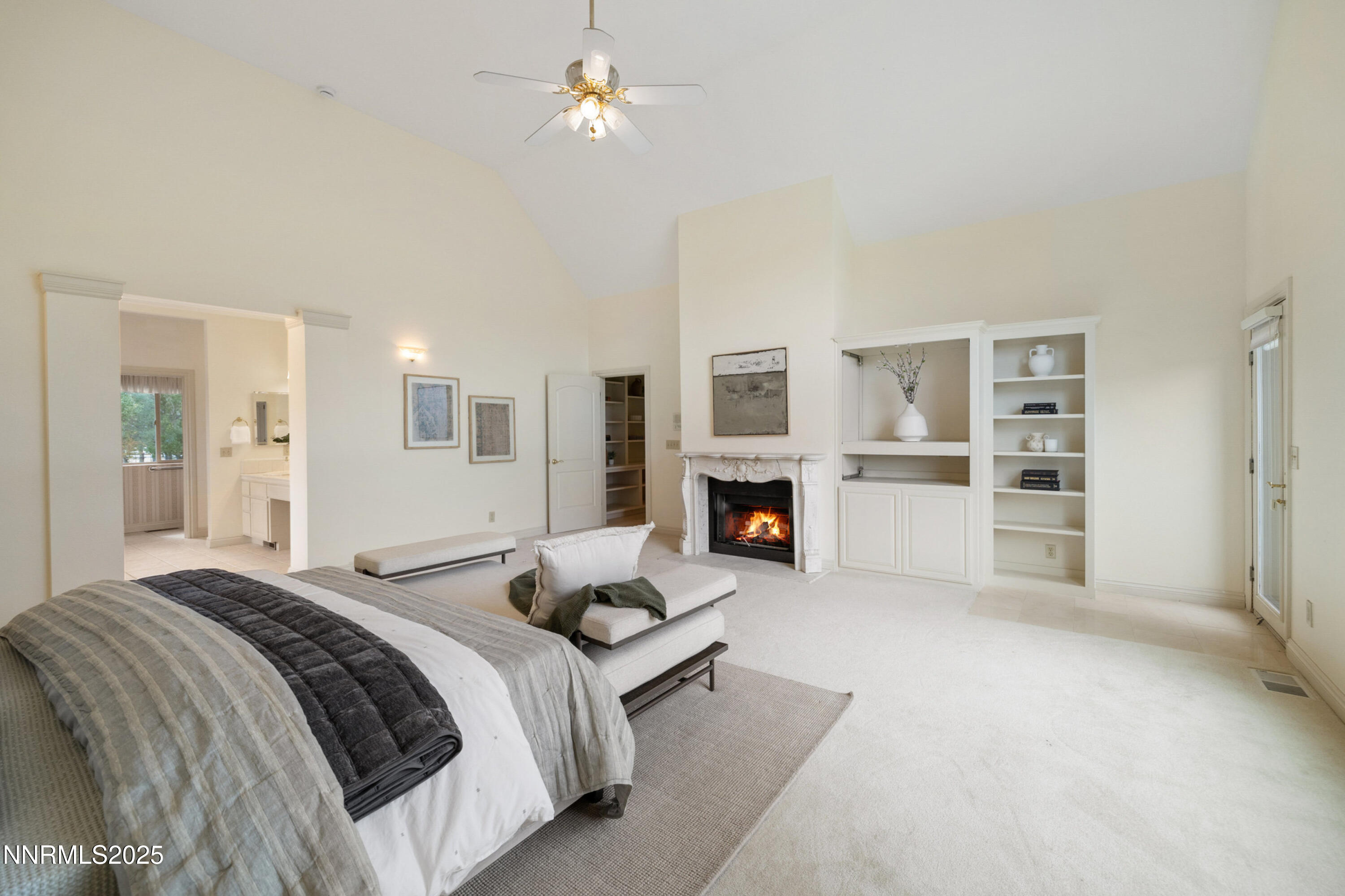 370 Genoa Lane Minden, NV 89423 - Photo 33 of 54 a spacious bedroom with a large bed a fireplace and windows