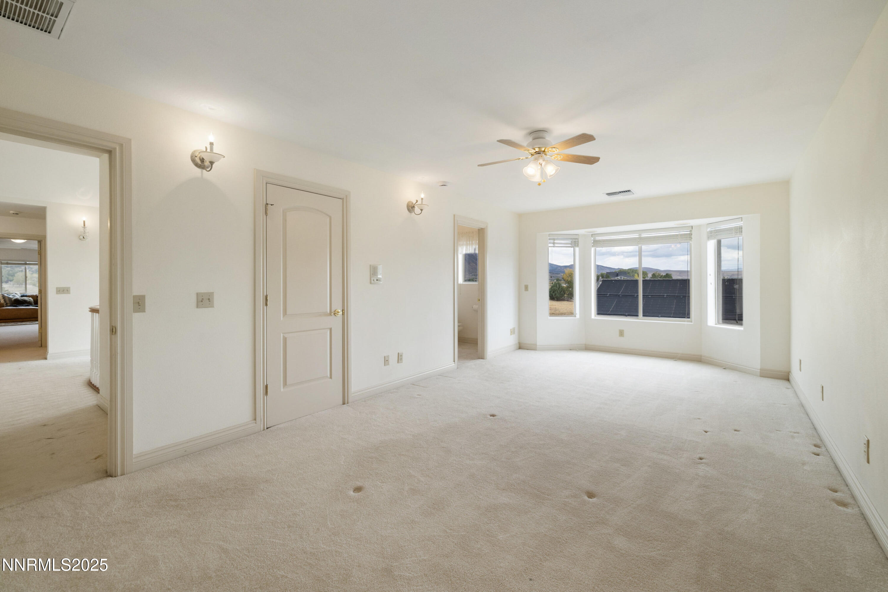 370 Genoa Lane Minden, NV 89423 - Photo 44 of 54 an empty room with chandelier fan and windows