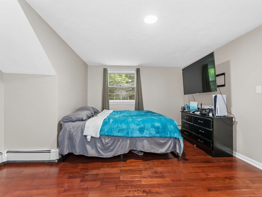 263 Cordaville Road Ashland, MA 01721 - Photo 11 of 18 a bedroom with a bed and a flat screen tv