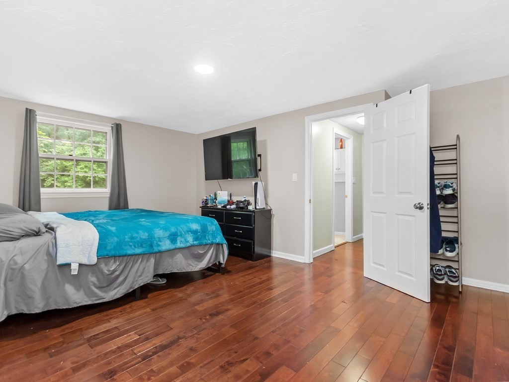 263 Cordaville Road Ashland, MA 01721 - Photo 12 of 18 a bedroom with a bed and wooden floor