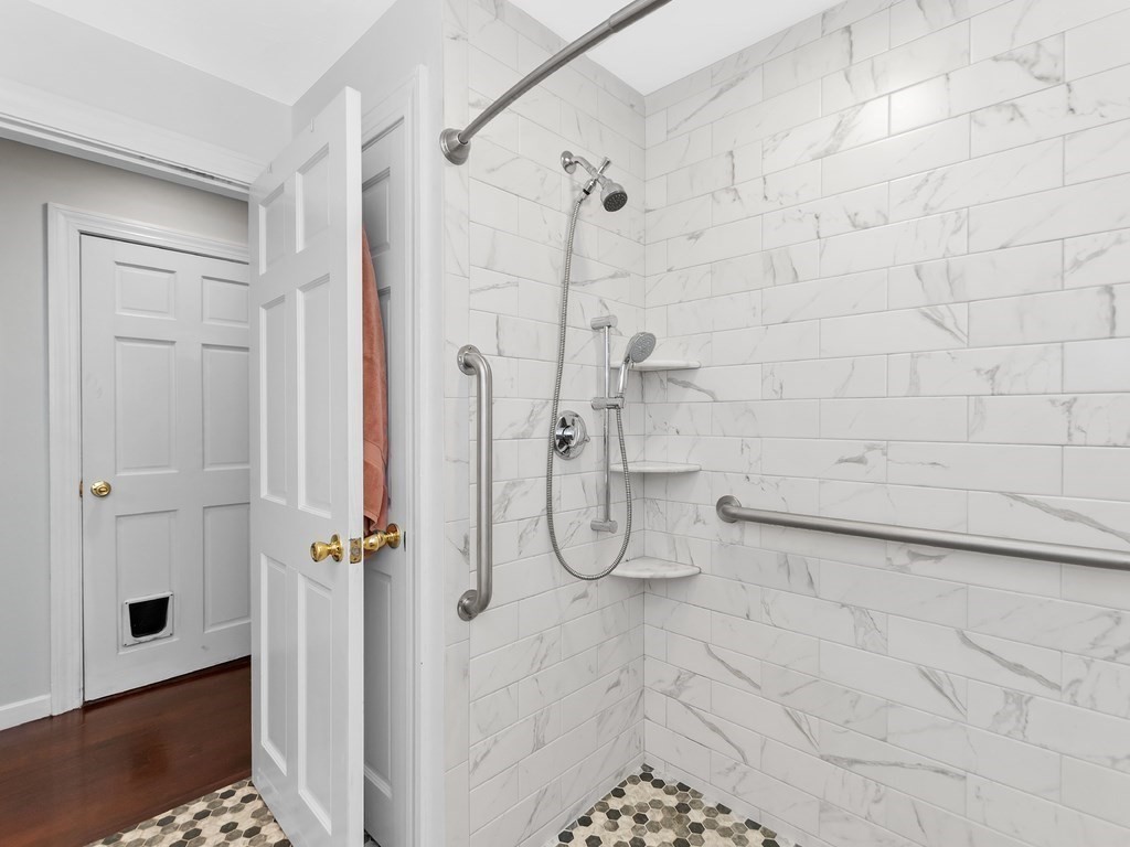 263 Cordaville Road Ashland, MA 01721 - Photo 7 of 18 a bathroom with a glass shower door