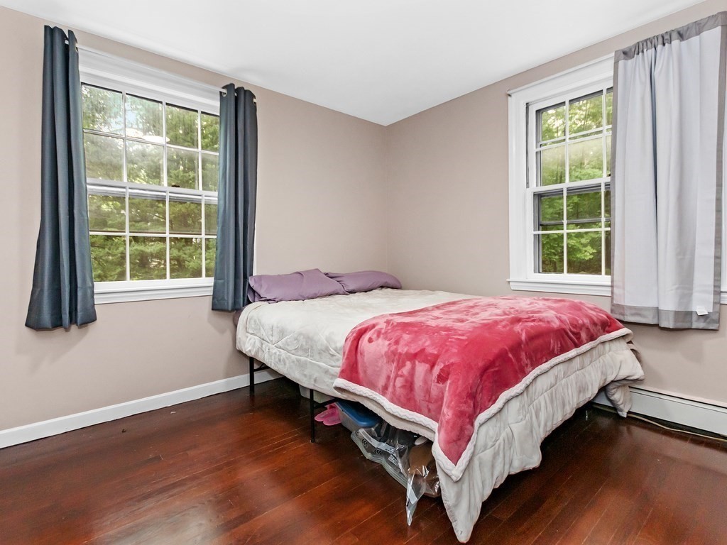 263 Cordaville Road Ashland, MA 01721 - Photo 10 of 18 a large bed sitting in a bedroom next to a window