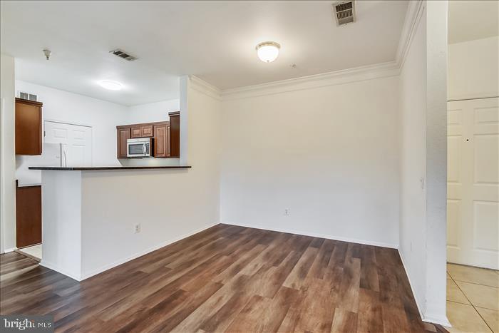 1601 Spring Gate Dr., Unit 1110 McLean, VA 22102 - Photo 13 of 26 a view of a room with wooden floor and a window