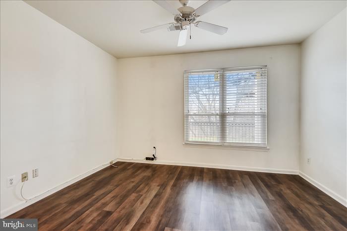 1601 Spring Gate Dr., Unit 1110 McLean, VA 22102 - Photo 21 of 26 an empty room with wooden floor and windows