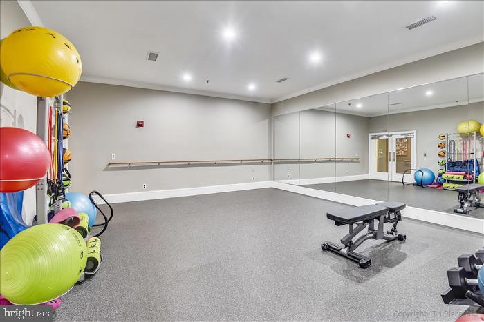 1601 Spring Gate Dr., Unit 1110 McLean, VA 22102 - Photo 7 of 26 a room with table and gym equipment