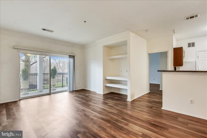 1601 Spring Gate Dr., Unit 1110 McLean, VA 22102 - Photo 10 of 26 a view of empty room with wooden floor and fan
