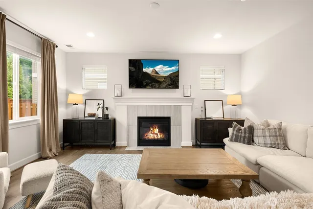 a living room with furniture and view of kitchen