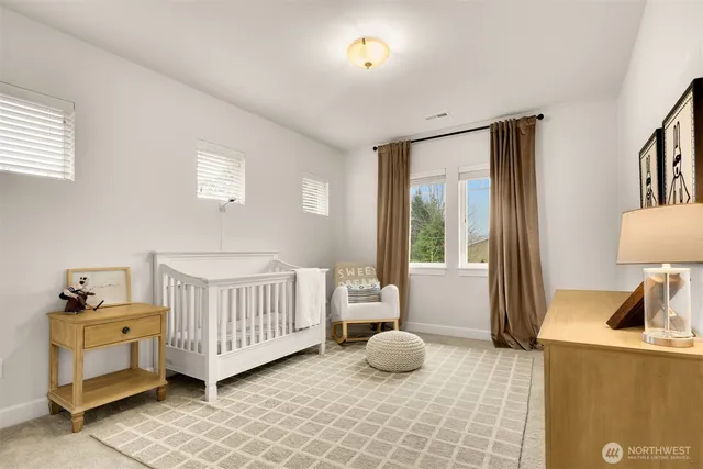 a bedroom with a bed and large window