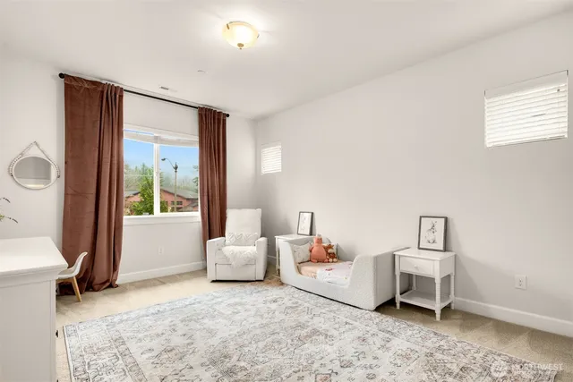 a view of a bedroom with a bed and the door