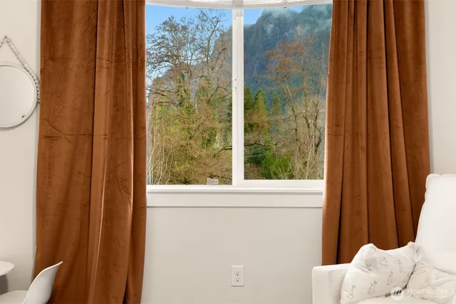a bathroom with a granite countertop double vanity sink a mirror and a toilet