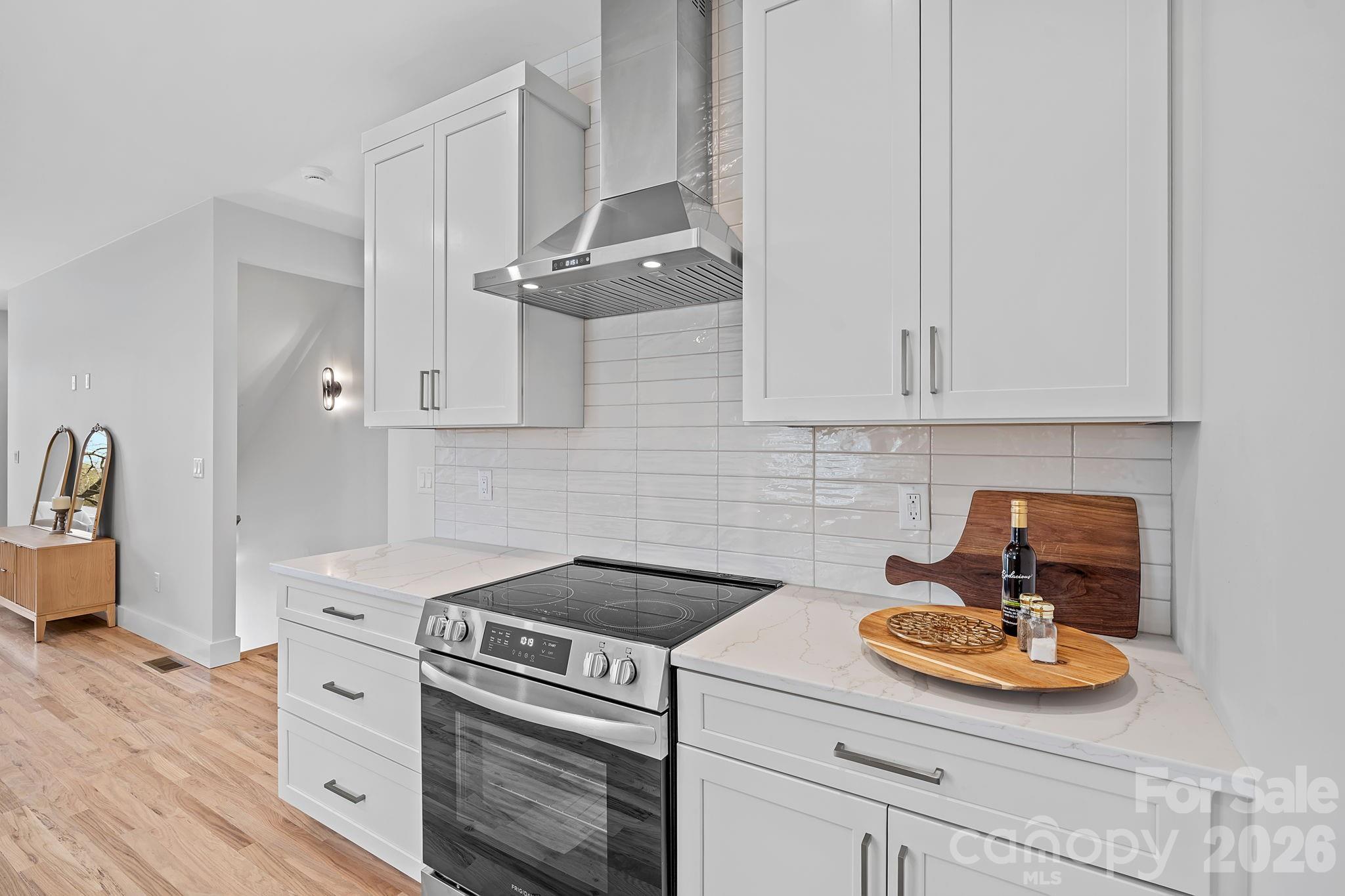 9 Gudger Road Asheville, NC 28715 - Photo 12 of 43 a kitchen with stainless steel appliances white cabinets and a stove top oven