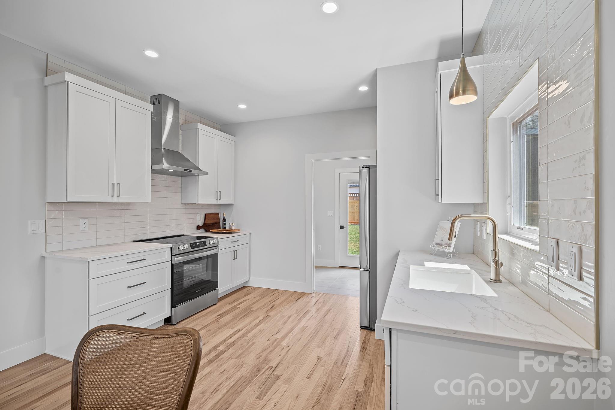 9 Gudger Road Asheville, NC 28715 - Photo 15 of 43 a kitchen with stainless steel appliances granite countertop a sink stove and refrigerator