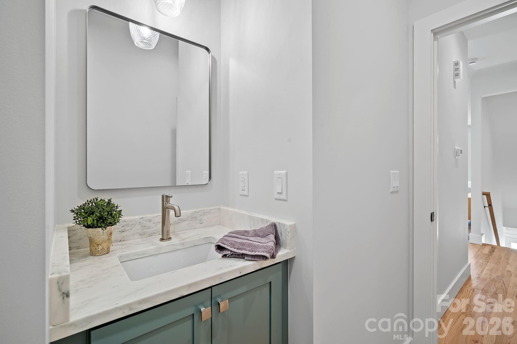 9 Gudger Road Asheville, NC 28715 - Photo 18 of 43 a bathroom with a granite countertop sink and a mirror