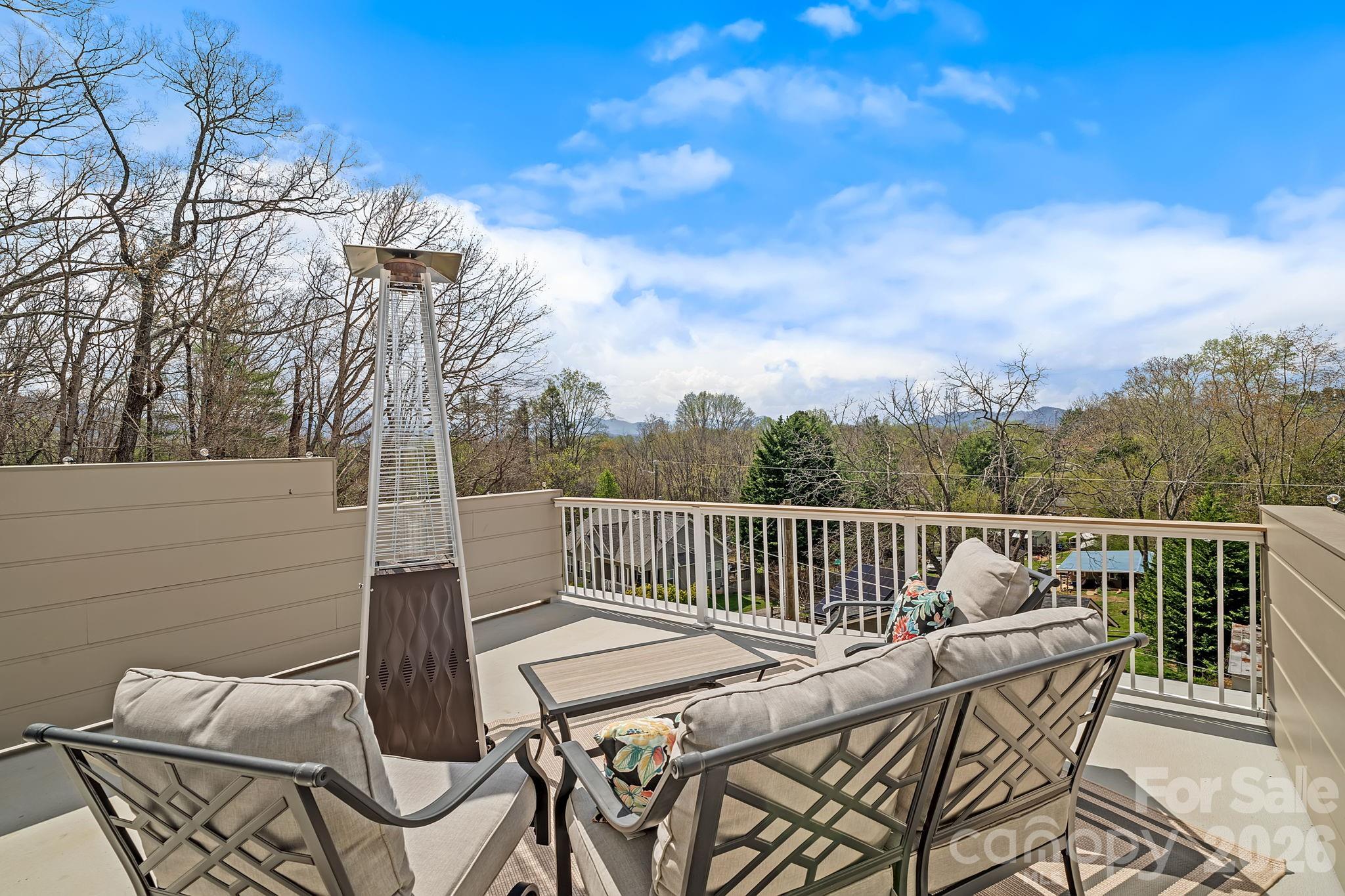 9 Gudger Road Asheville, NC 28715 - Photo 24 of 43 a roof deck with table and chairs and potted plants