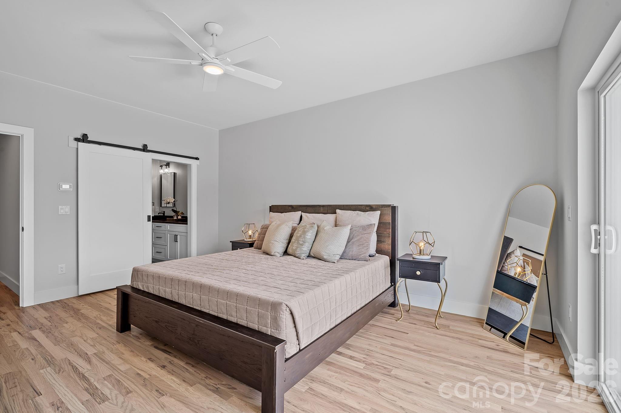 9 Gudger Road Asheville, NC 28715 - Photo 26 of 43 a spacious bedroom with a bed and a dresser
