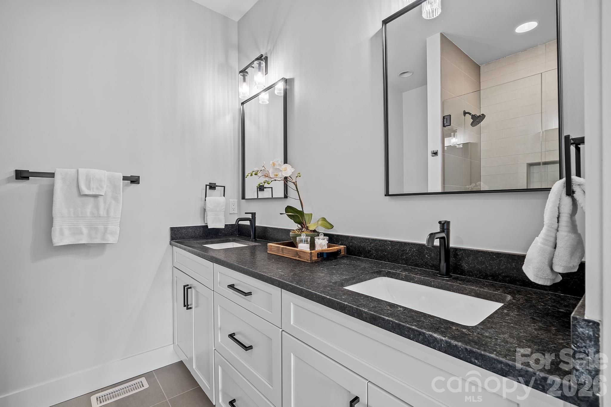 9 Gudger Road Asheville, NC 28715 - Photo 27 of 43 a bathroom with sinks and mirror