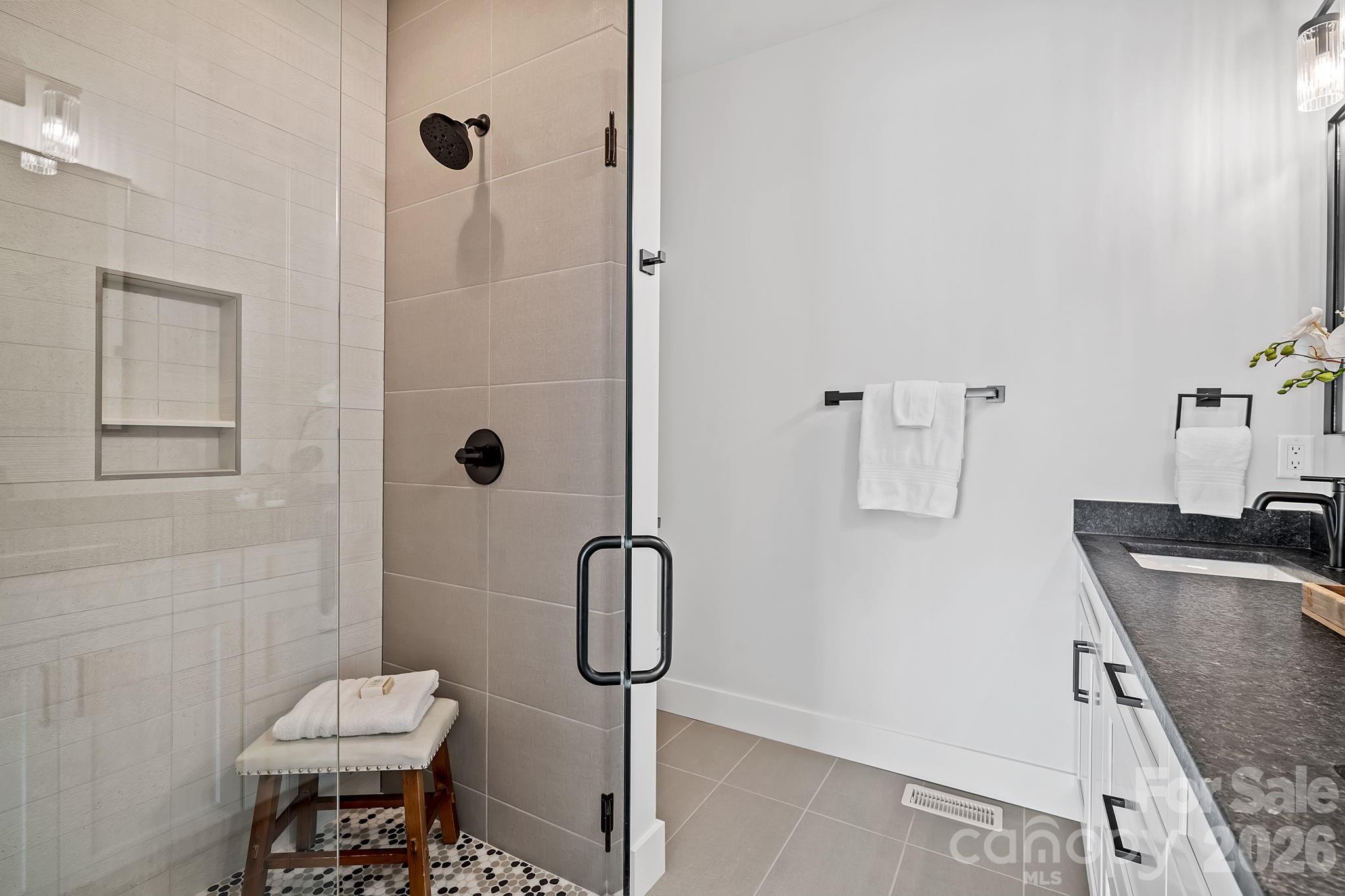 9 Gudger Road Asheville, NC 28715 - Photo 28 of 43 a bathroom with a granite countertop sink a toilet and shower
