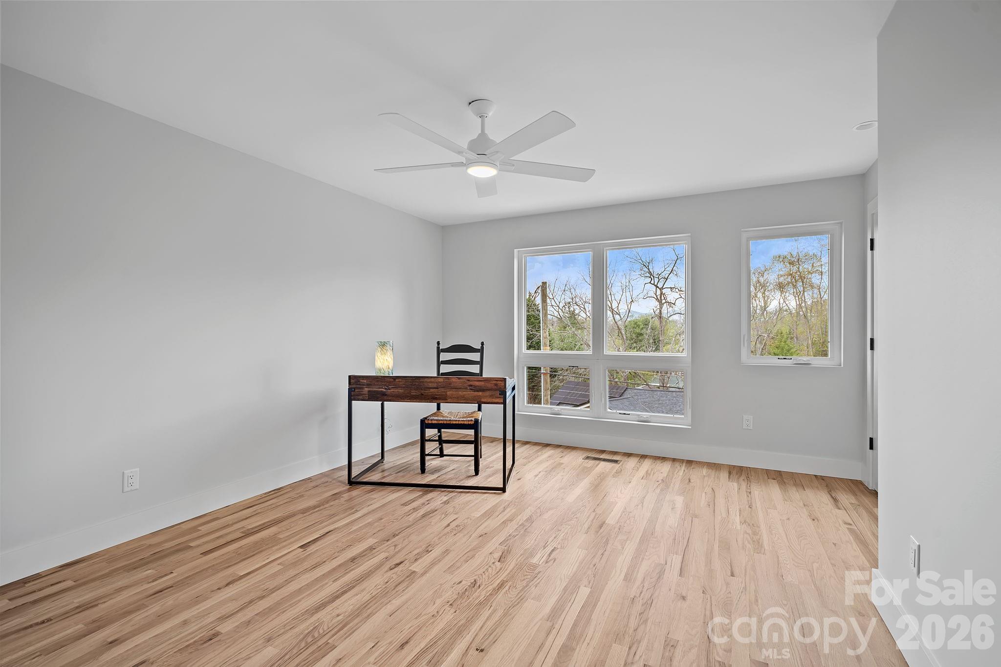 9 Gudger Road Asheville, NC 28715 - Photo 32 of 43 a view of a workspace with wooden floor and a window