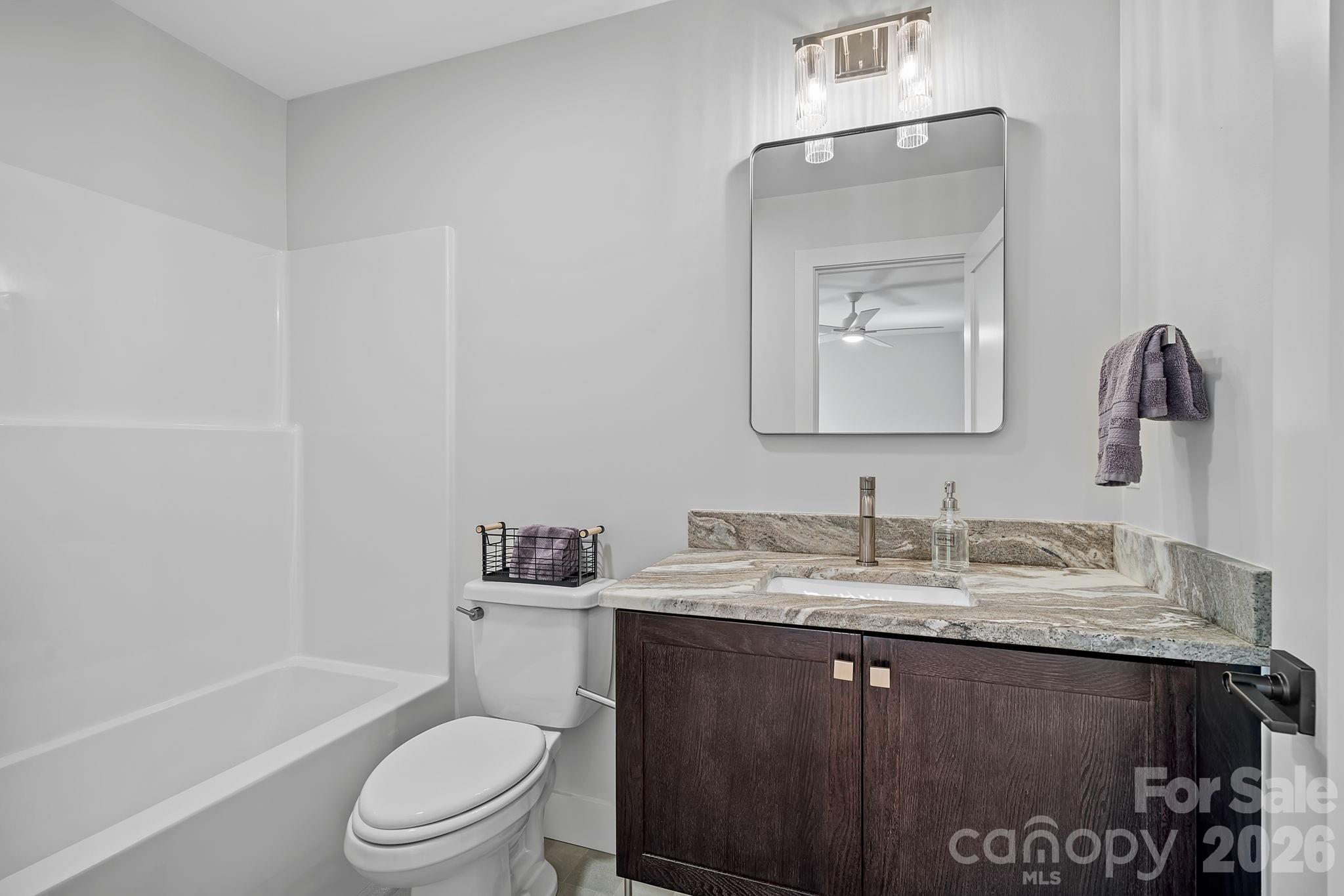 9 Gudger Road Asheville, NC 28715 - Photo 37 of 43 a bathroom with a granite countertop sink a toilet and a bathtub