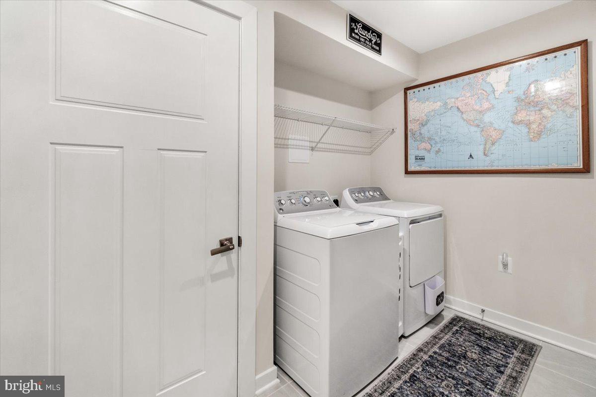 312 Hammersmith Circle Frederick, MD 21702 - Photo 12 of 41 a utility room with a sink a washer and dryer
