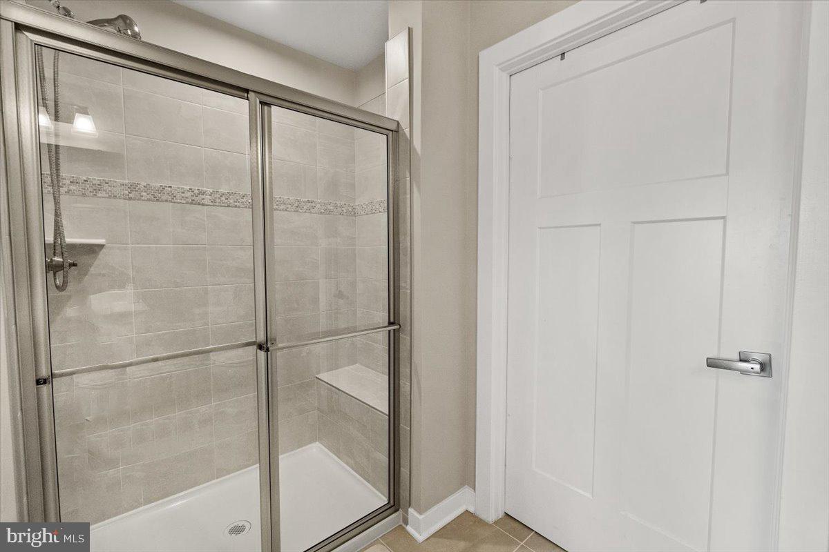 312 Hammersmith Circle Frederick, MD 21702 - Photo 17 of 41 a bathroom with a glass shower door