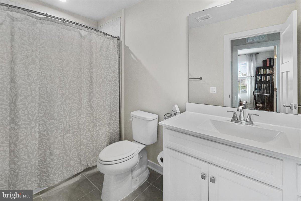312 Hammersmith Circle Frederick, MD 21702 - Photo 20 of 41 a bathroom with a sink a toilet and shower curtain
