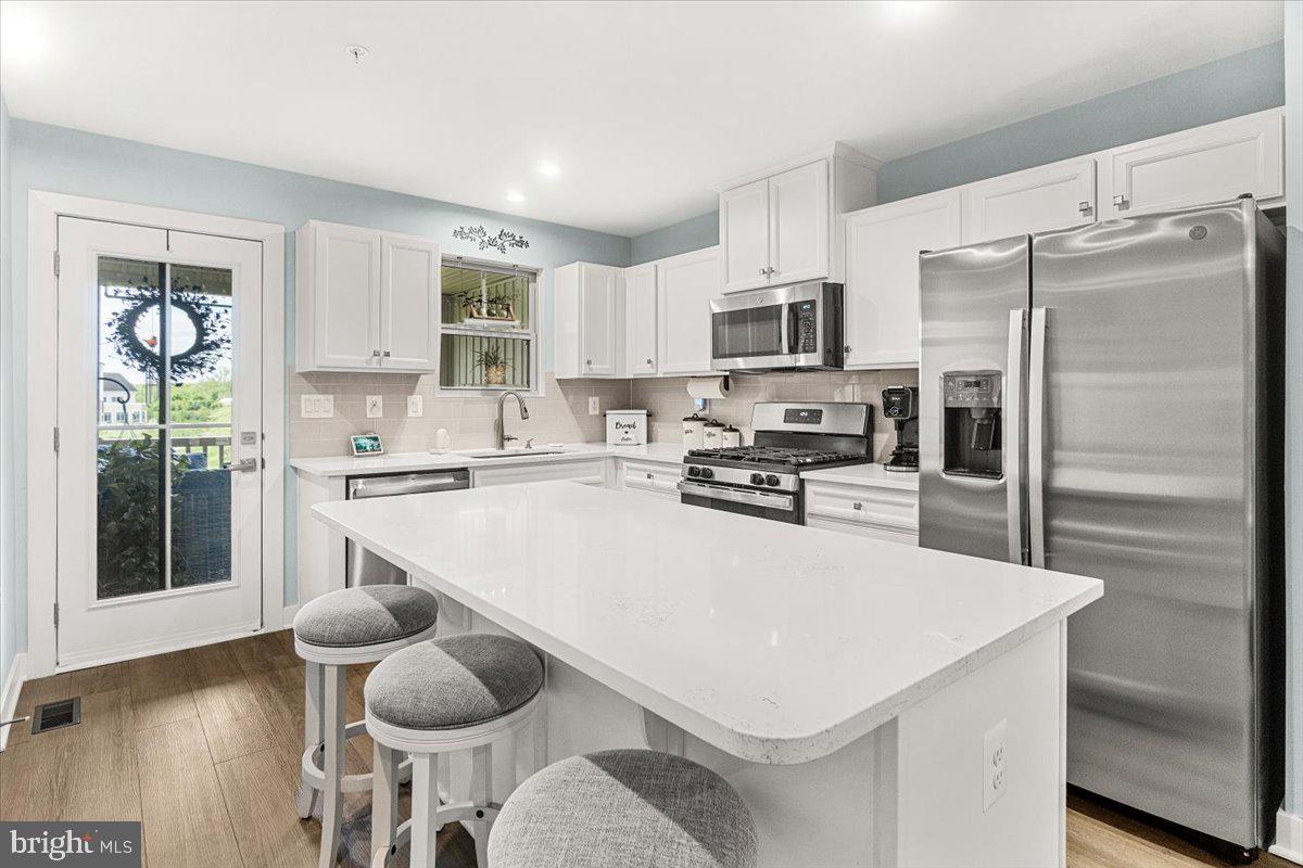 312 Hammersmith Circle Frederick, MD 21702 - Photo 7 of 41 a kitchen with a refrigerator a stove a sink and a cabinets