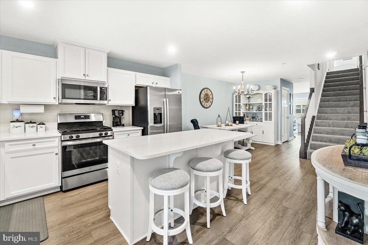 312 Hammersmith Circle Frederick, MD 21702 - Photo 9 of 41 a kitchen with a stove and white cabinets