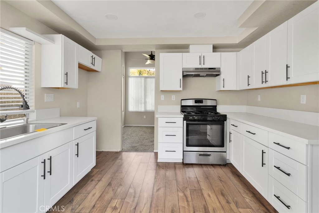 40243 Mimulus Way Temecula, CA 92591 - Photo 11 of 33 a kitchen with stainless steel appliances a stove sink and cabinets