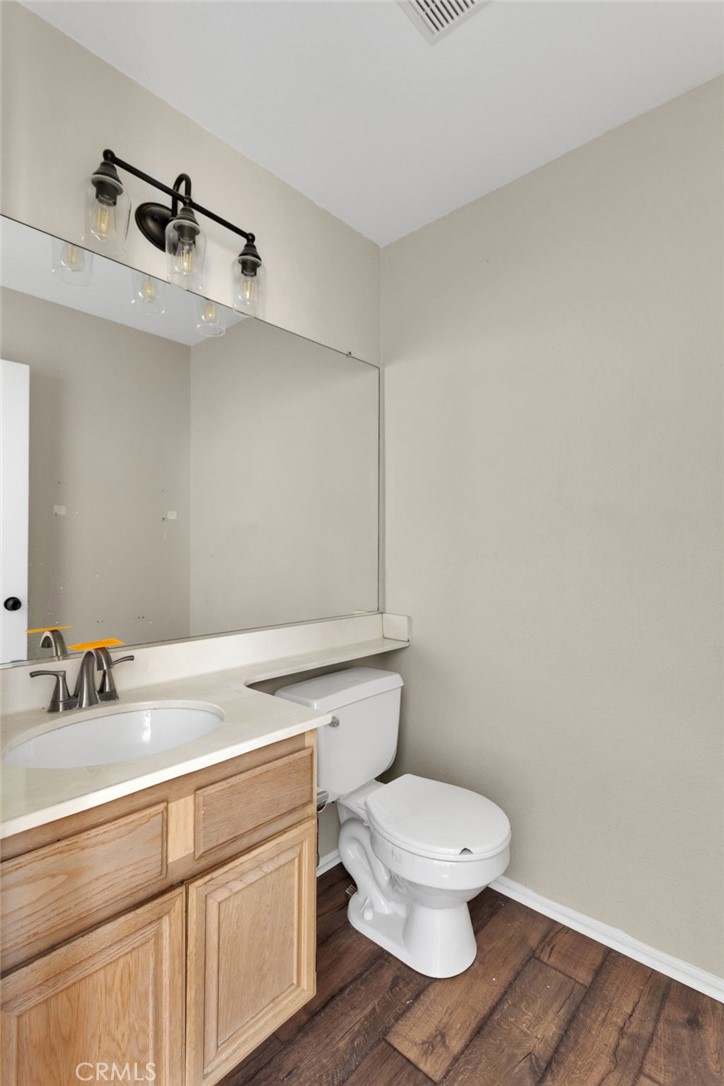 40243 Mimulus Way Temecula, CA 92591 - Photo 18 of 33 a bathroom with a toilet a sink and mirror