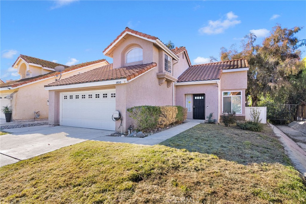 40243 Mimulus Way Temecula, CA 92591 - Photo 3 of 33 a front view of a house with a yard and garage