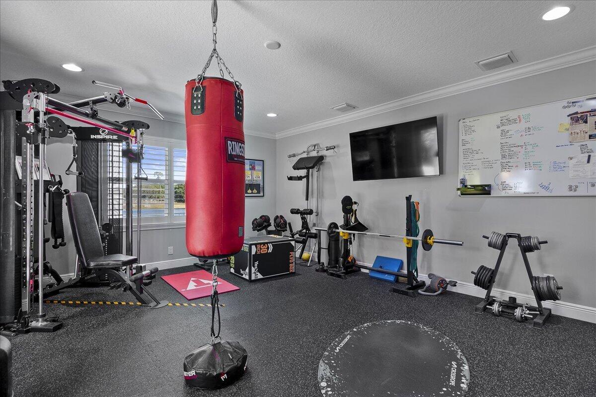 10975 Randolph Siding Road Jupiter, FL 33478 - Photo 70 of 97 a view of a room with gym equipment
