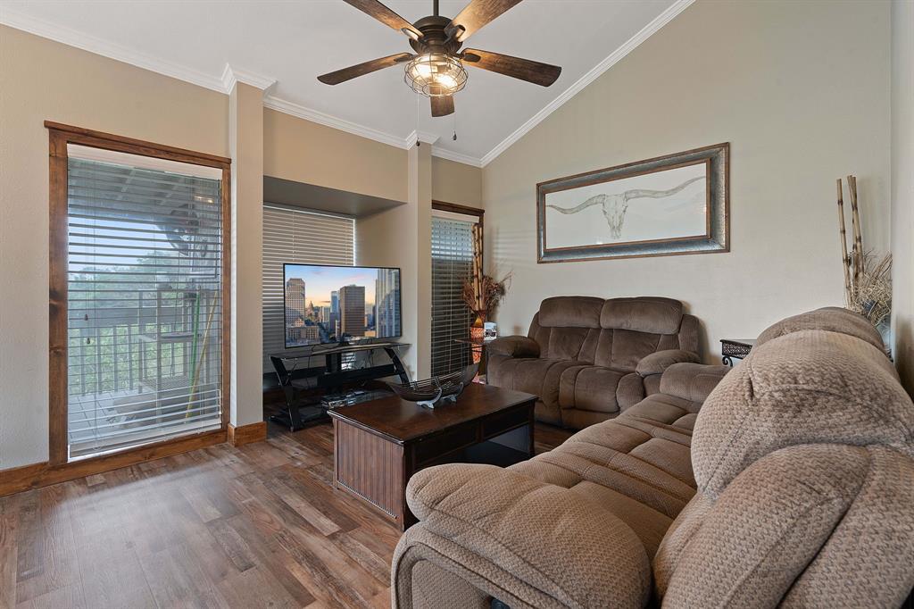321 Venture Boulevard South Leander, TX 78645 - Photo 7 of 23 Living room with lofted ceiling, a ceiling fan, wood finished floors, and crown molding