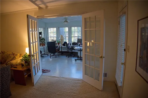 a view of a workspace with furniture and a potted plant
