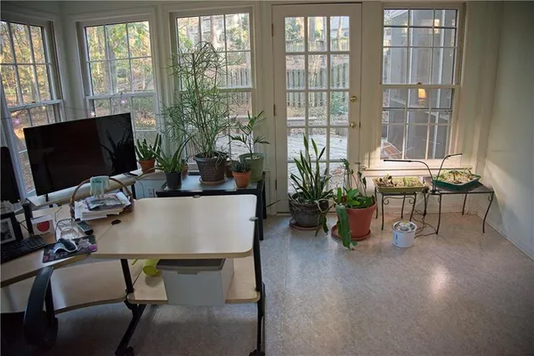a view of a workspace with furniture and a window