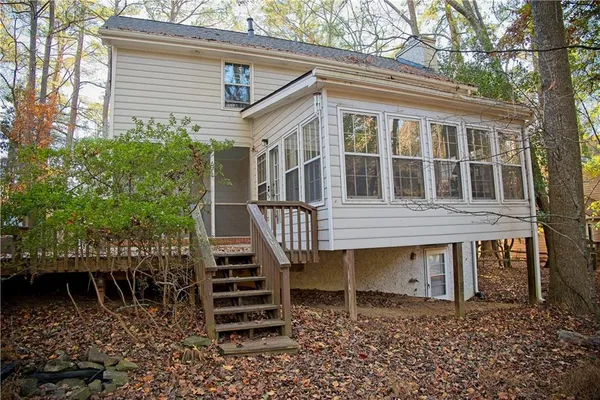a backyard of a house with table and chairs